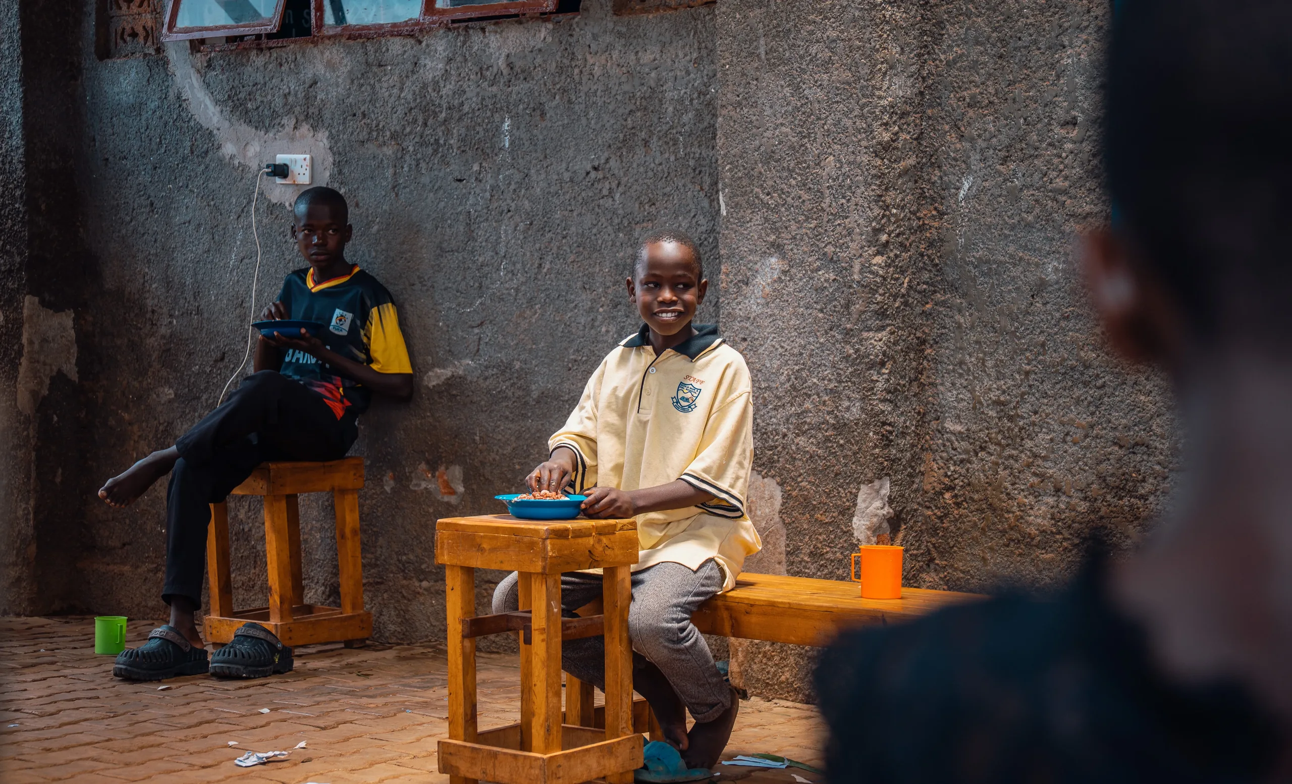 Children sharing a meal and clean drinking water at an Amuno learning site